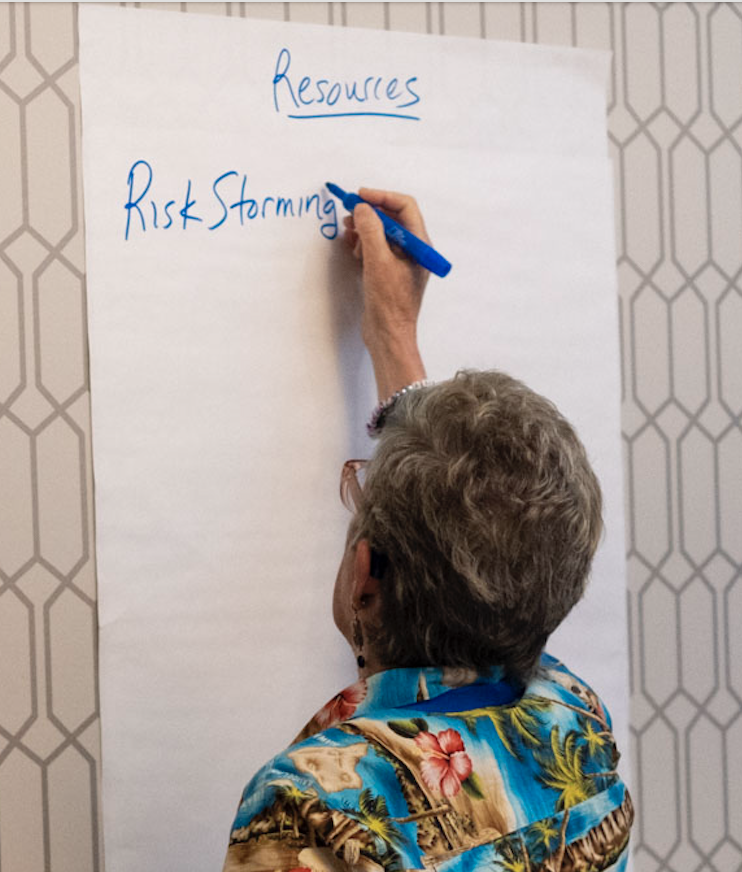 Lisa writing on flipchart paper